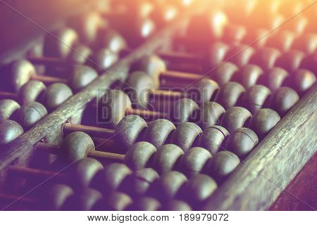 vintage wooden abacus on wood table used for calculating.