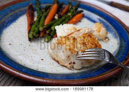 White Flakey Sea Bass With Breadcrumbs And Roasted Asparagus And Carrots