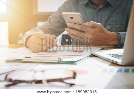 Business process photo. Account manager using mobile phone. Typing contemporary smartphone screen