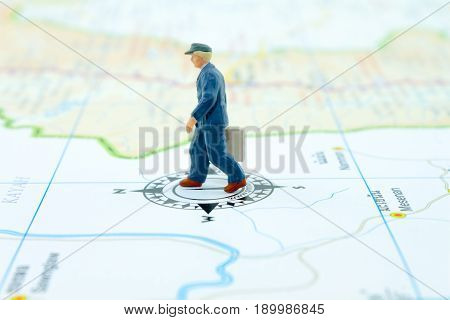 miniature businessman people walking on the map travel concept