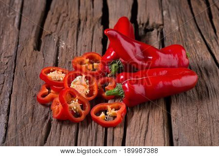 Red Chilly Pepper On Wooden Black Background. Red Hot Chili Peppers.