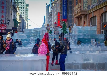 Harbin, China - February 9, 2017: Unknown tourists visiting the ice sculptures in Zhongyang pedestrian street, central street is a commercial long corridor of European architectural art