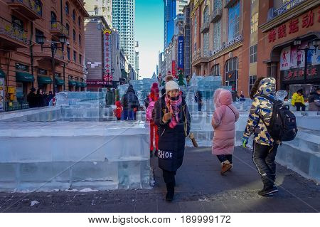 Harbin, China - February 9, 2017: Unknown tourists visiting the ice sculptures in Zhongyang pedestrian street, central street is a commercial long corridor of European architectural art