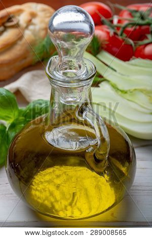 Virgin Natural Olive Oil Is Glass Bottle, Served With Traditional Mediterranean Food
