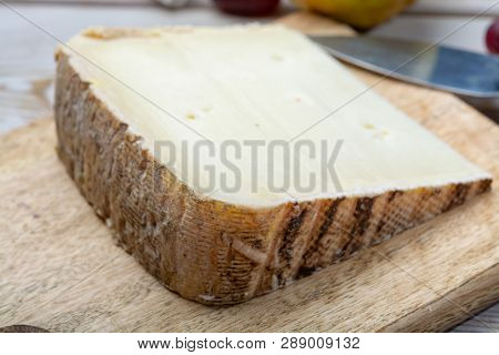 Piece Of French Cheese Tomme De Brebis Made From Sheep Milk Served As Dessert With Fresh Figs And Pe