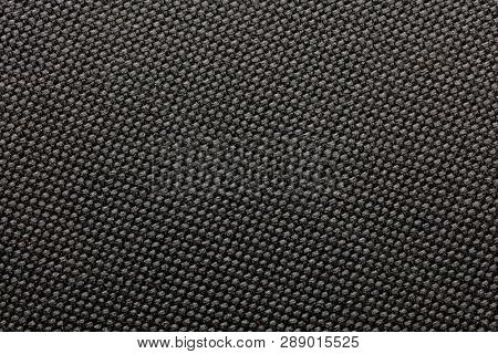 Black nylon or synthetic material fabric texture. Often used for tough durable gear and wear.