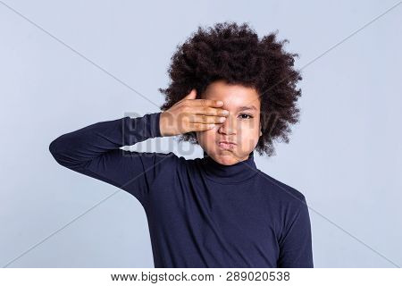 Funky Dark-skinned Little Men Inflating His Cheeks And Closing One Eye