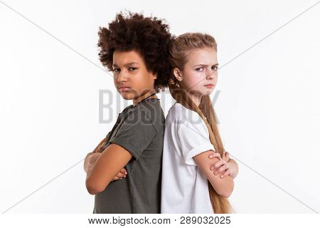 Angry Upset Kids Standing Back To Back With Crossed Hands
