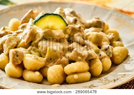 Tasty Gnochi With Cheese Sauce And Zuchini On Plate