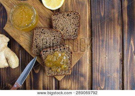 Sliced Homemade Bread With Ginger Jam On The Cutting Board On The Brown Wooden Background.top View.c