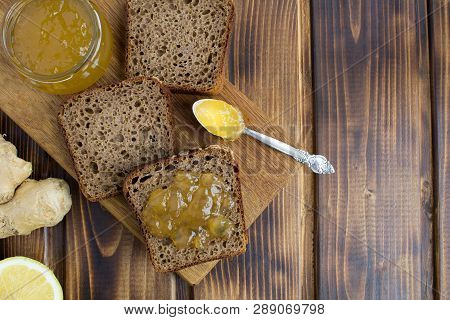 Sliced Homemade Bread With Ginger Jam On The Cutting Board On The Brown Wooden Background.top View.c