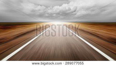 asphalt road through desert droughty area in cloudy day