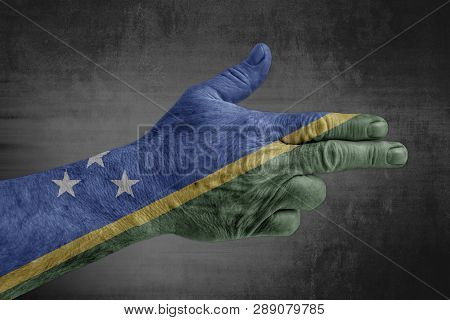 Solomon Islands Flag Painted On Male Hand Like A Gun