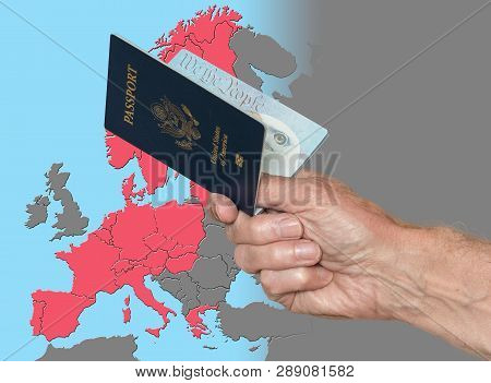Senior Man Holding Us Passport On Map Of Schengen Zone Of European Union In Preparation For Etias Vi