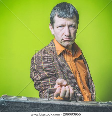 Portrait Of A Man Holding A Suitecase