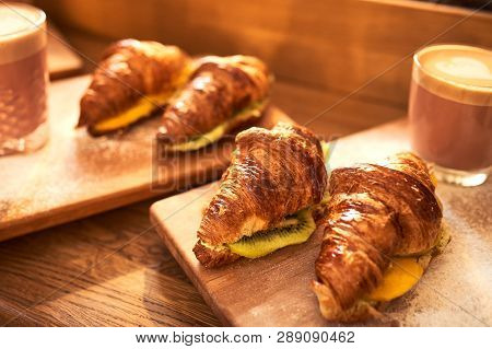 Fresh Croissant And Original Authors Coffee On Beet Milk With Fruits On Wooden Plate On Table. Healt
