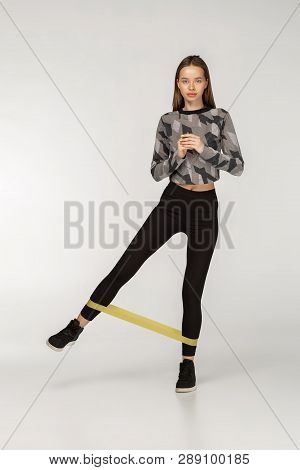 Healthy Woman With Good Physique Doing Stretching Work Out With Elastic Bands