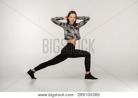 Indoor Shot Of Strong Athletic Woman Wearing Black Sports Outfit