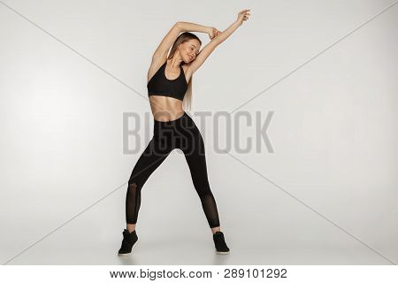 A Full Length Portrait Of A Sporty Woman In Stylish Black Sportwear