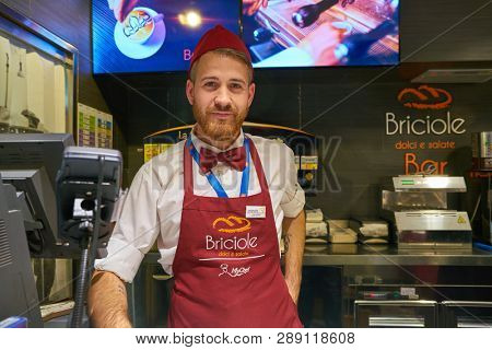 LINATE, ITALY - CIRCA NOVEMBER, 2017: indoor portrait of man at Briciole Bar in Milan Linate Airport.