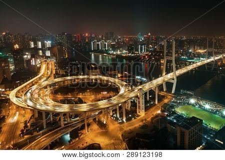 Shanghai Nanpu Bridge over Huangpu River with busy traffic in China.