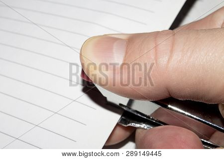 Stapling Paper With Staples.stapler In The Hand Of Man.