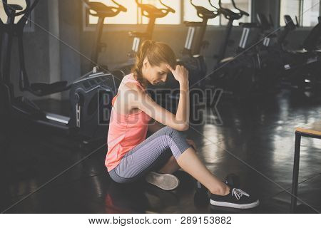 Women Sitting And Relax After The Training Session,concept Healthy And Lifestyle,female Tired With T