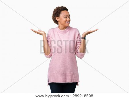 Beautiful young african american woman over isolated background Smiling showing both hands open palms, presenting and advertising comparison and balance