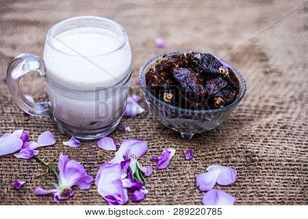 Close Up Of Dates And Raw Milk In A Glass On Gunny Bag Used To Make Date Milk Or Dry Fruit Milk.