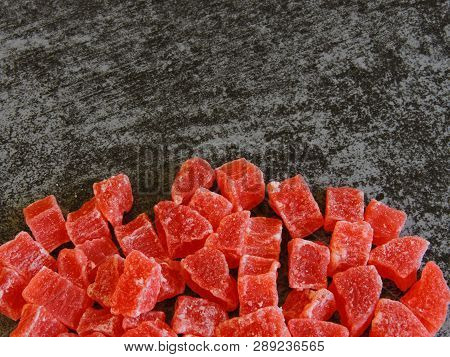 A Bunch Of Red Candied Fruits. Background Gray Loft.
