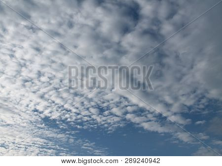Beautiful Alto Cumulus Cloud Formations On A Deep Blue Sky