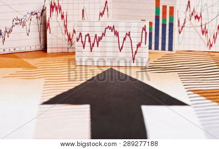 Black Arrow Points To Different Charts With Stock Market Prices