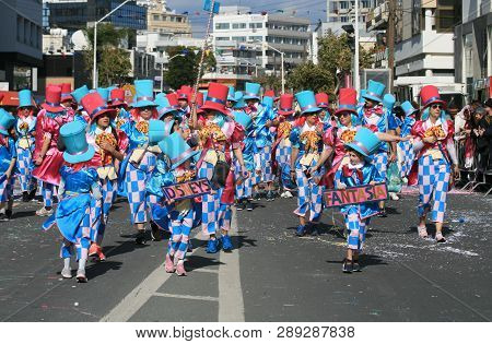 Limassol, Cyprus, March 10th, 2019: Group Of People In Bright Carnival Costumes And Top Hats Walking