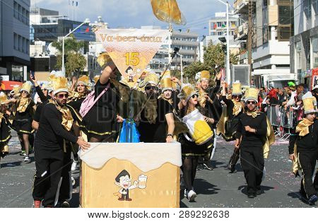 Limassol, Cyprus, March 10th, 2019: Group Of Beer Lovers In Carnival Costumes Walking Along Archbish