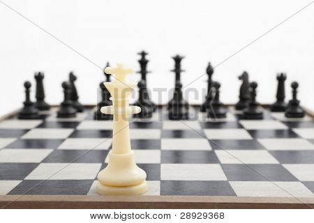 Fallen king pieces surrounded by the other color chess pieces