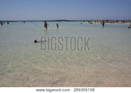 Greece, Elafonisi - August 07, 2018: Tourists On Elafonisi Beach, Crete Island Landmark. Paradise Be