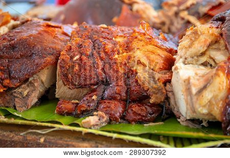 Roasted Pork Meat Cooked On Grill. Traditional Cuisine. Sliced Pork Barbecue With Gold Skin. Spanish