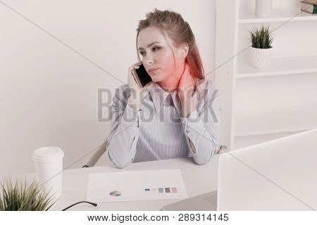 Office Woman Sitting Infront Of The Computer At Her Workplace And Feeling Neckache. Sad Worker Feeli