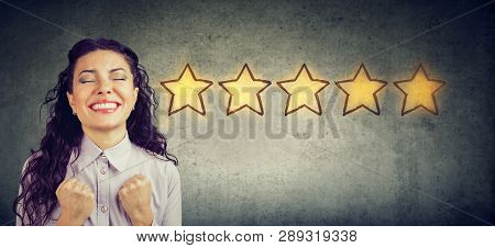 Сheerful Beautiful Woman Smiling Celebrating Five Stars Rating For Service Provided. Excellent Custo
