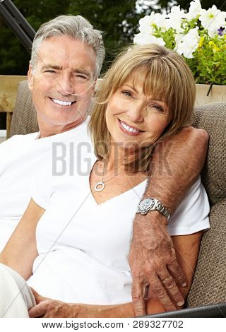 happy elderly couple hugging