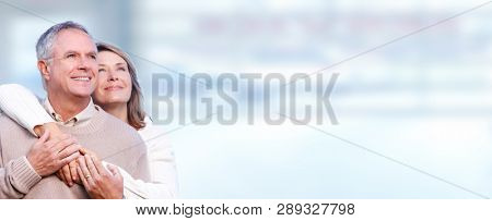 happy elderly couple hugging