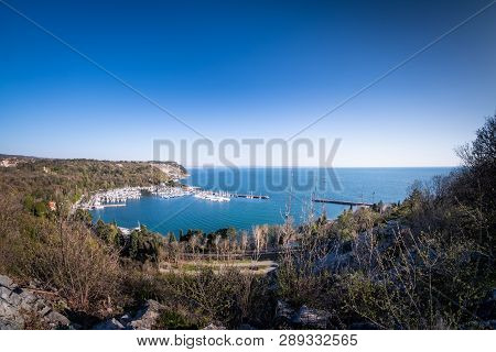 Panoramic View To Bay Of Holiday Resort Sistiana With Harbor And Beach On A Sunny Day In Spring Near