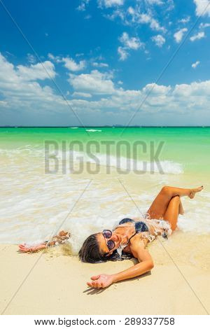 Woman enjoying her holidays on a transat at the tropical beach in Thailand