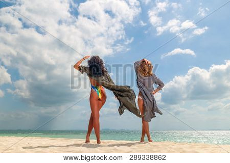 Two Women enjoying their holidays on a transat at the tropical beach in Thailand