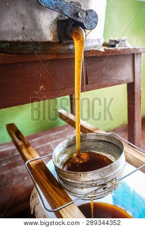 Strain The Honey Through The Sieve From The Honeypot. Close-up Beekeeper Uncapping. Beekeeping Conce