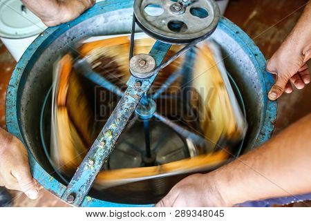 Close-up Beekeeper Is Uncapping Honeycomb. Beekeeping Concept. Authentic Lifestyle Image. Top View. 