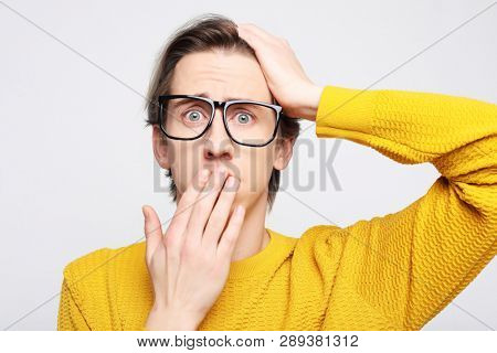 lifestyle, happiness, emotional and people concept: photo of stupefied handsome male has shocked expression, being surprised, isolated overwhite background. Astonished young crazy man feels stress.