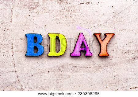 Inscription Bd Bday Birthday Colored Abbreviation In Wooden Letters On A Light Background.