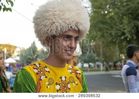 September, 3, 2017. Ashgabat, Turkmenistan : Smiling Young Man In In National Costume Before The Per