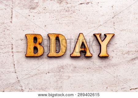 Inscription Bd Bday Birthday Abbreviation In Wooden Letters On A Light Background.